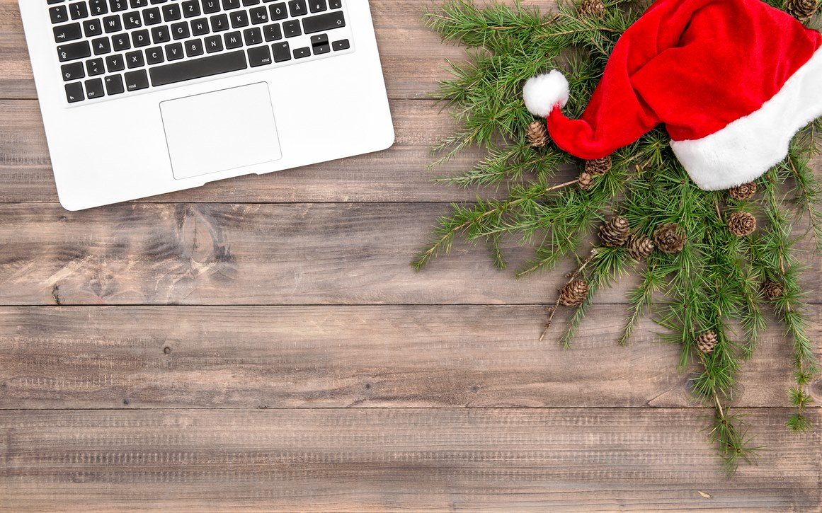 Laptop, Santa hat and Christmas wreath.